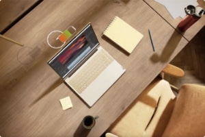 Overhead view of Lenovo Slim laptop open 90 degrees sitting on a desk