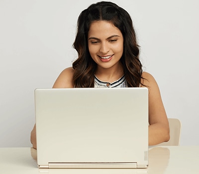 A young lady working on a Yoga Slim placed on a desk