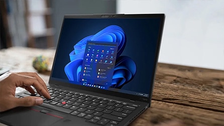 Close-up of a ThinkPad X1 Nanon keyboard and display, with someone typing something
