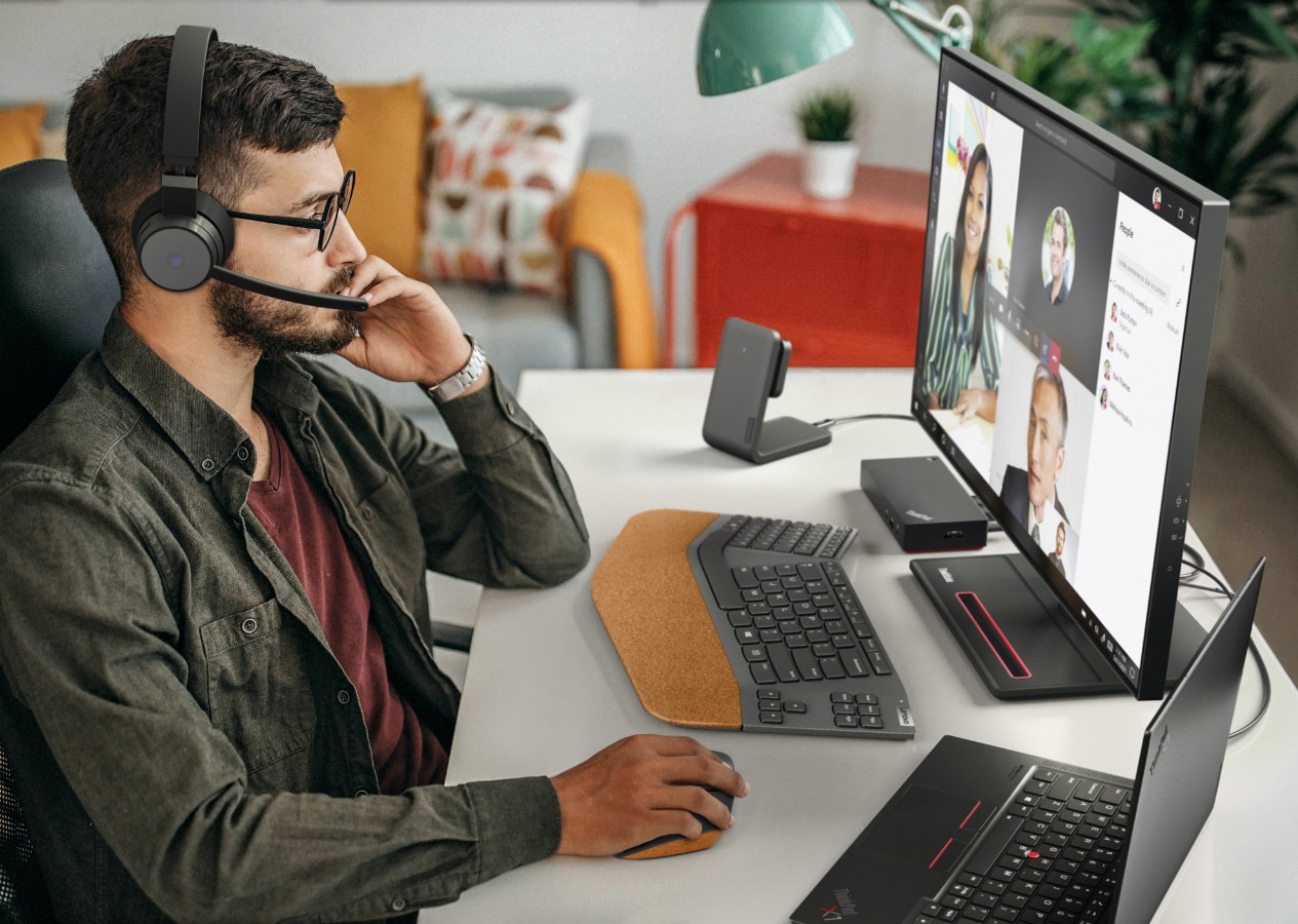 Hombre usando accesorios Lenovo Go en un entorno de oficina en casa