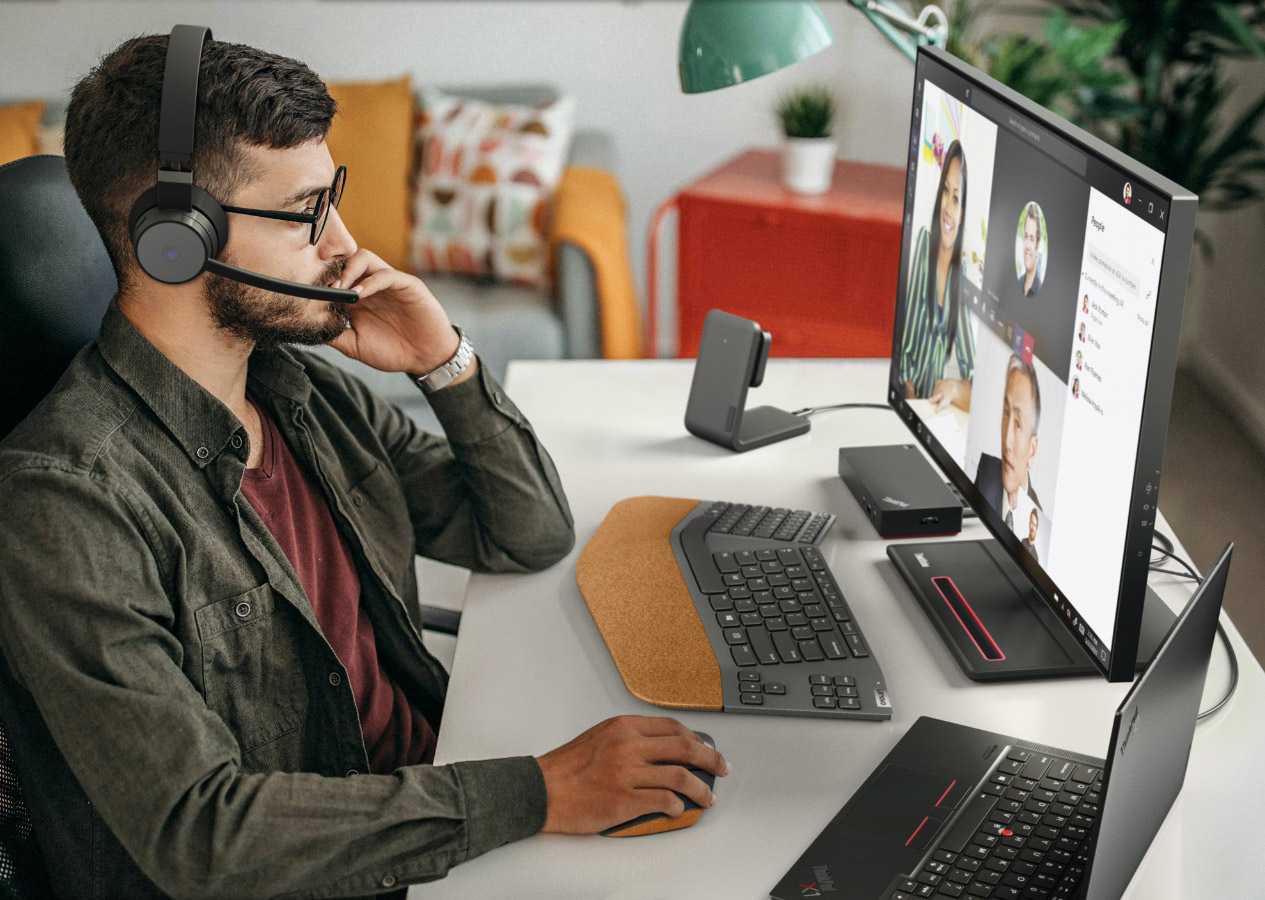 Man using Lenovo Go accessories in a home office setting