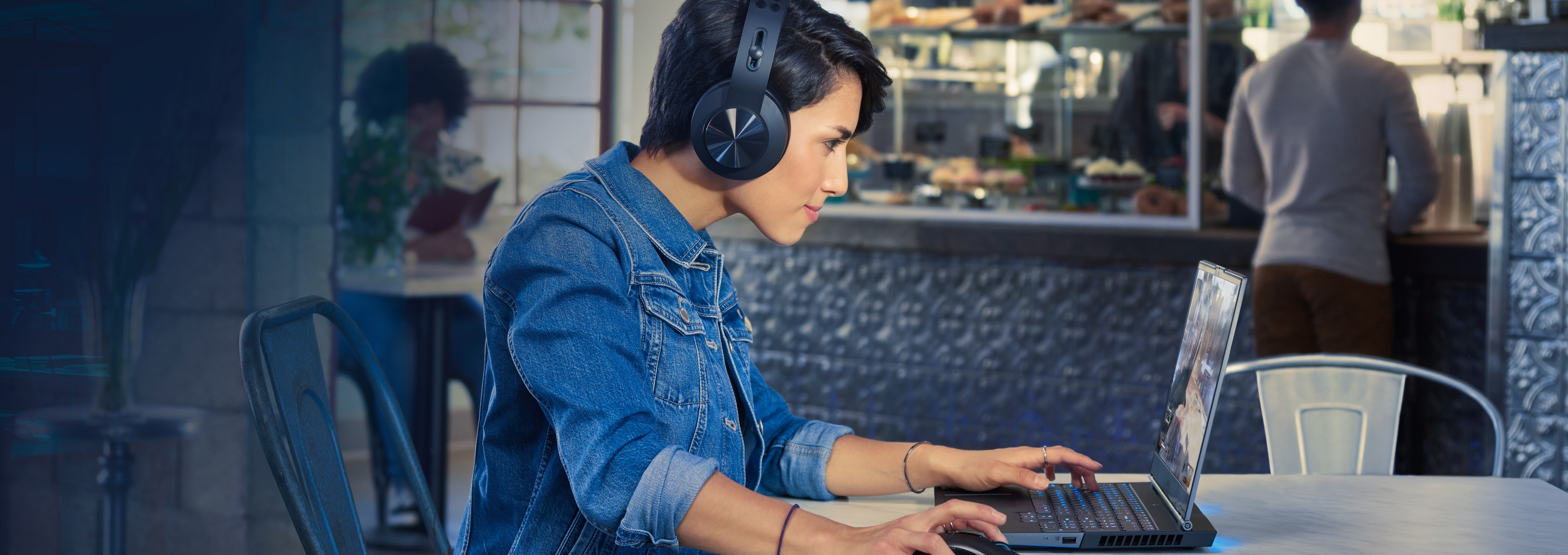 Girl with headphones holding a Lenovo Laptop, and a alter game character of her