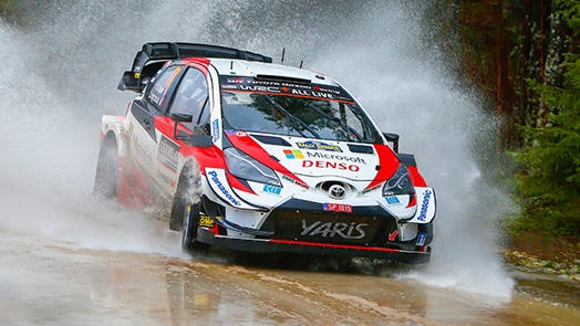 Toyota race car driving through water