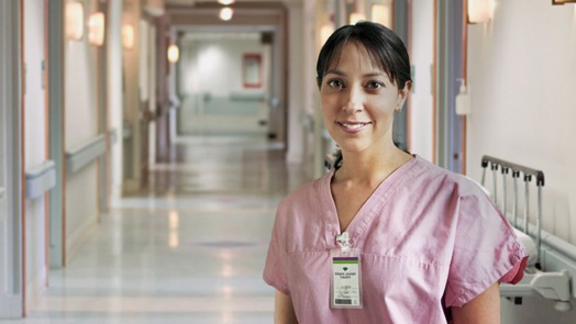 Success - nurse standing in hospital hallway