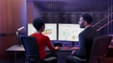 Woman and man in a data center collaborating on hybrid cloud solutions