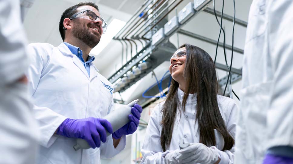 A group of people in a lab wearing lab coats