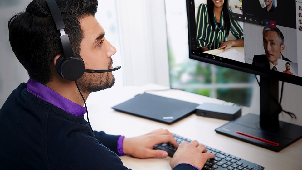 Person wearing headset working at Lenovo Workstation