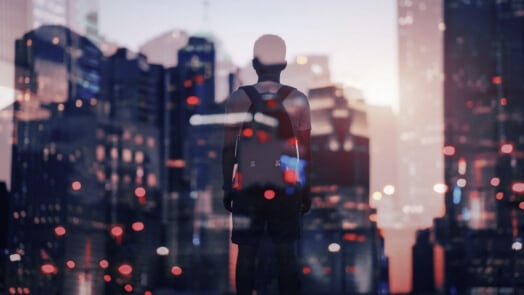 Person looking out a large window in an urban setting