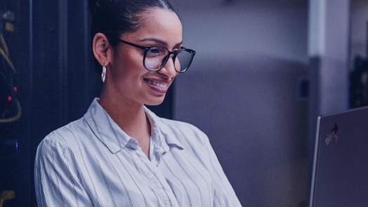 Vrouw die werkt aan een bureau in IT-omgeving