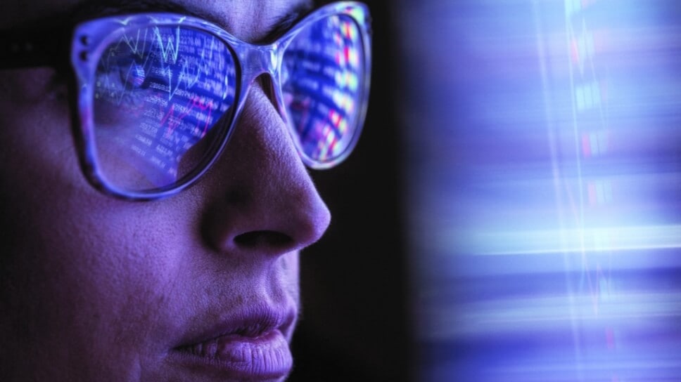 Person with data reflecting in glasses